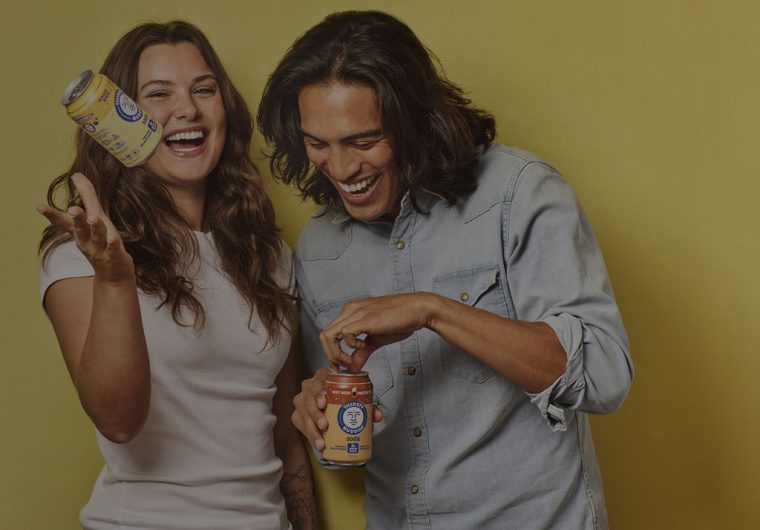 happy couple holding buddha brands products and laughing