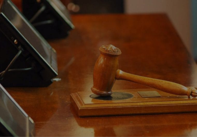 A gavel rests on a desk