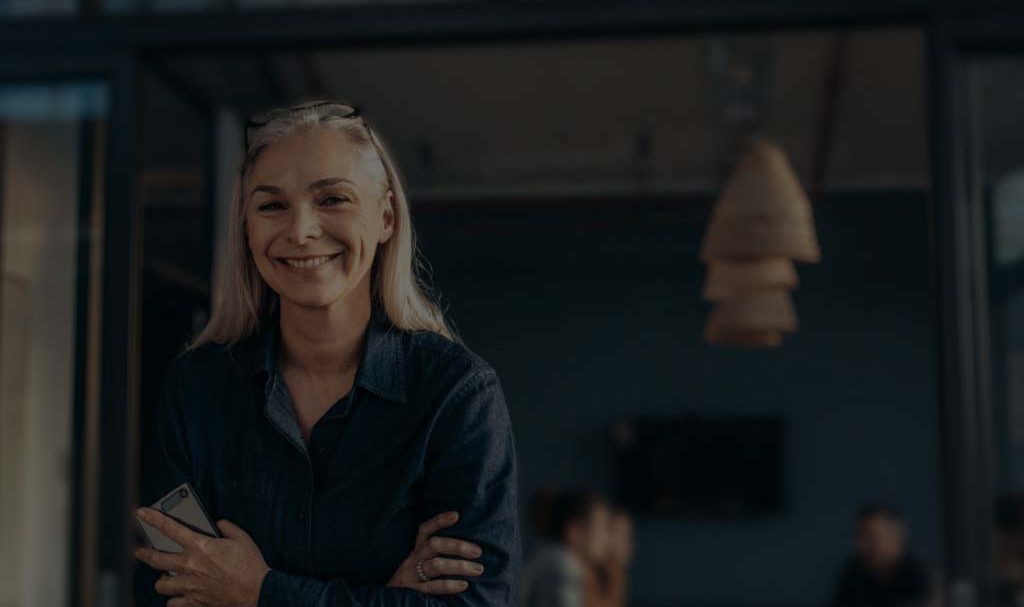 A background image for FieldEdge of a woman standing with her arms folded