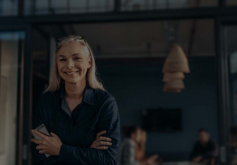 A background image for FieldEdge of a woman standing with her arms folded