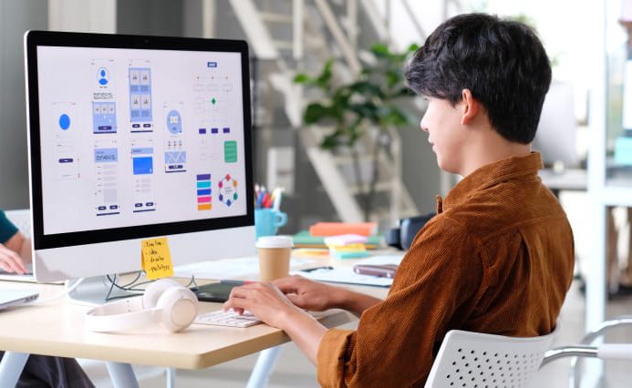 A web designer creating designs on their computer