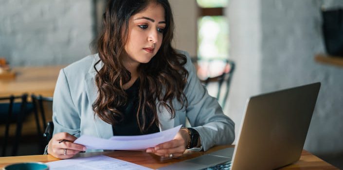 Woman at computer writes the copy for a Plumber Web Design