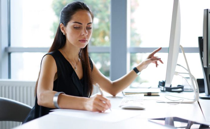 Woman prepares Plumber Web Design at her desk