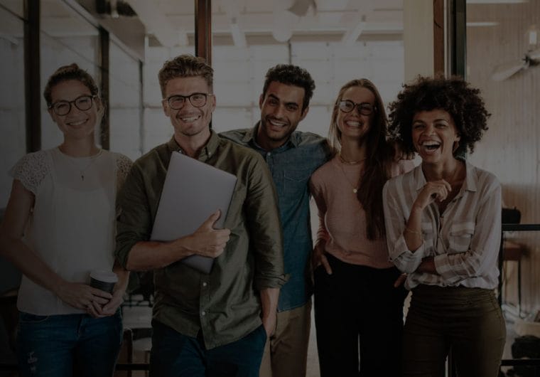 Five people stand next to each other smiling