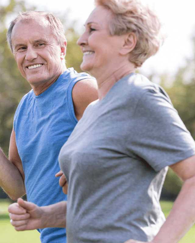 Two joggers smiling at eachother